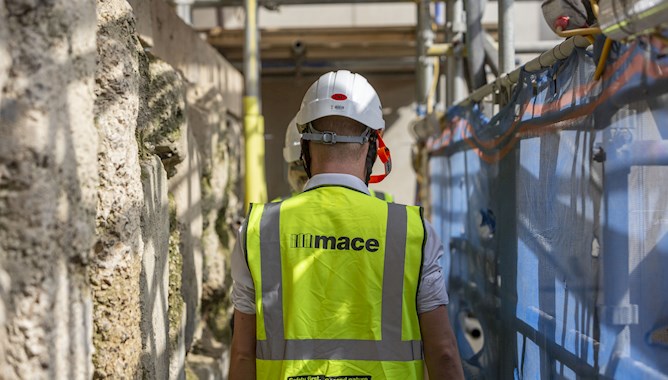 Man wearing a hivis jacket and helmet
