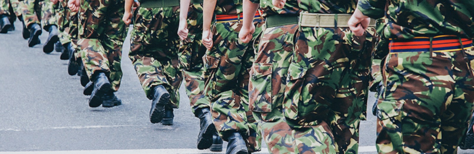 soldiers walking in camouflage trousers 