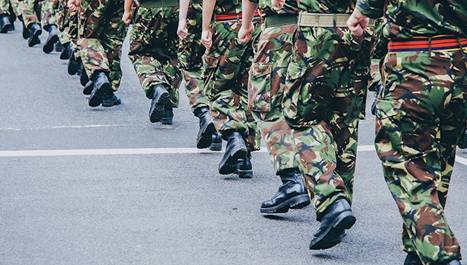 soldiers walking in camouflage trousers 