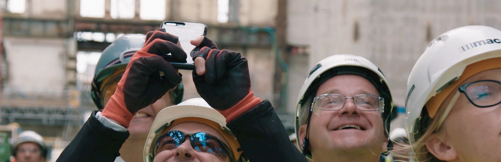 Mace Construction Worker Taking a Photo on his Phone - Mace Group