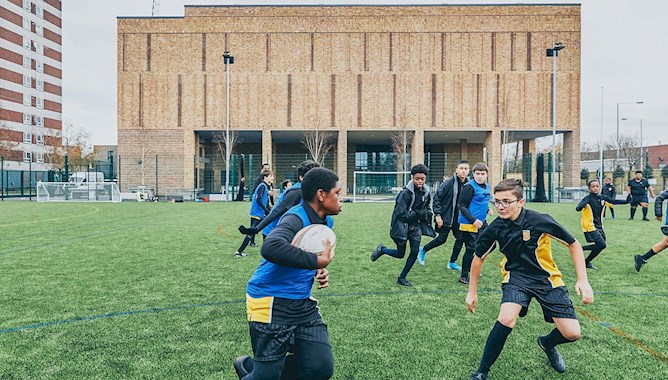 Boys playing rugby at school - Mace Group 