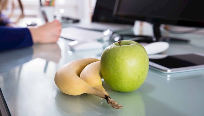 Banana and apple on a table 