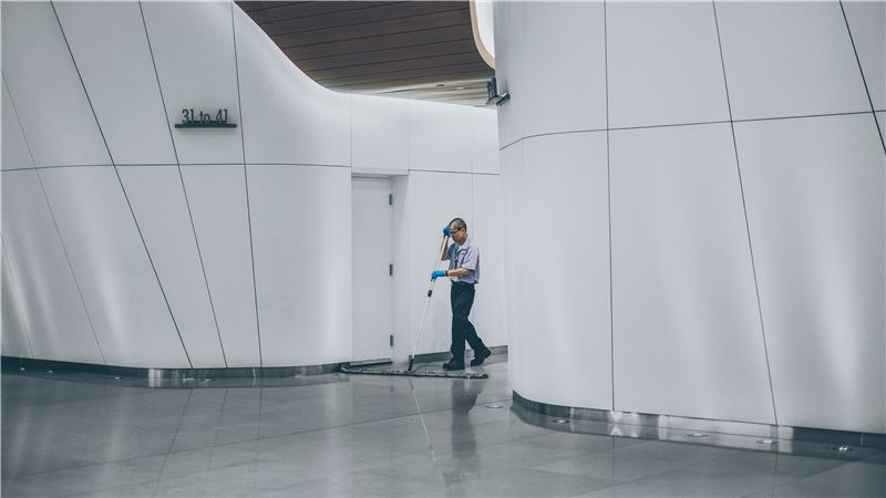 Male Cleaner Mopping a Building Floor - Mace Group