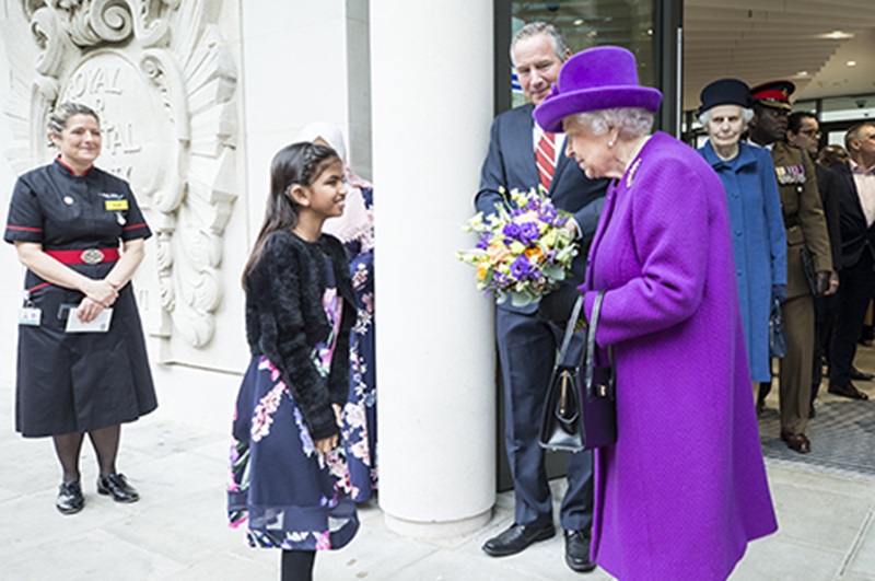 Her Majesty The Queen Speaking to a Young Girl - Mace Group