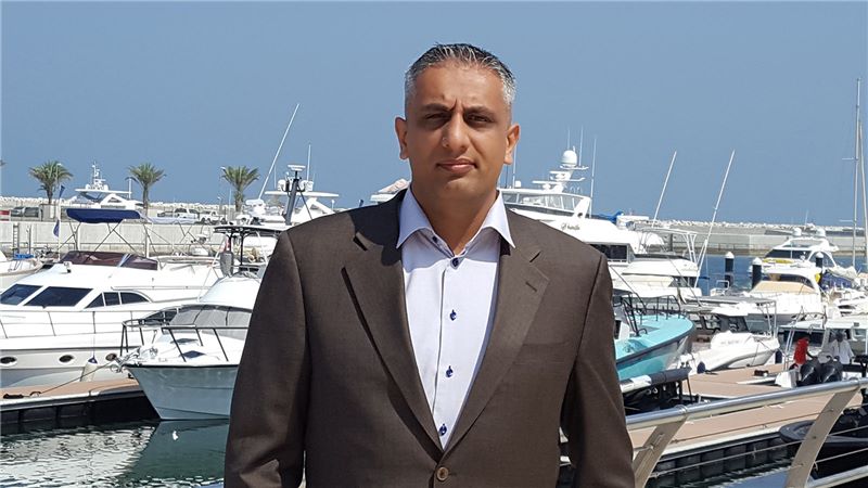 Portrait of Naveed Haque, Luxury Yachts in the Background - Mace Group
